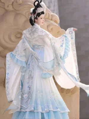 Back three-quarter view of embroidered Wei Jin Dynasty Qiyao Ruqun Hanfu showing layered skirt, cloud collar, tassel details, and flowing train