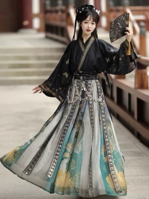 Front three quarter view of a Wei Jin Dynasty qiyao ruqun Hanfu with black cross collar top, gold trim, butterfly prints, colorful dragon and crane patterned skirt, and silver decorative waist chain