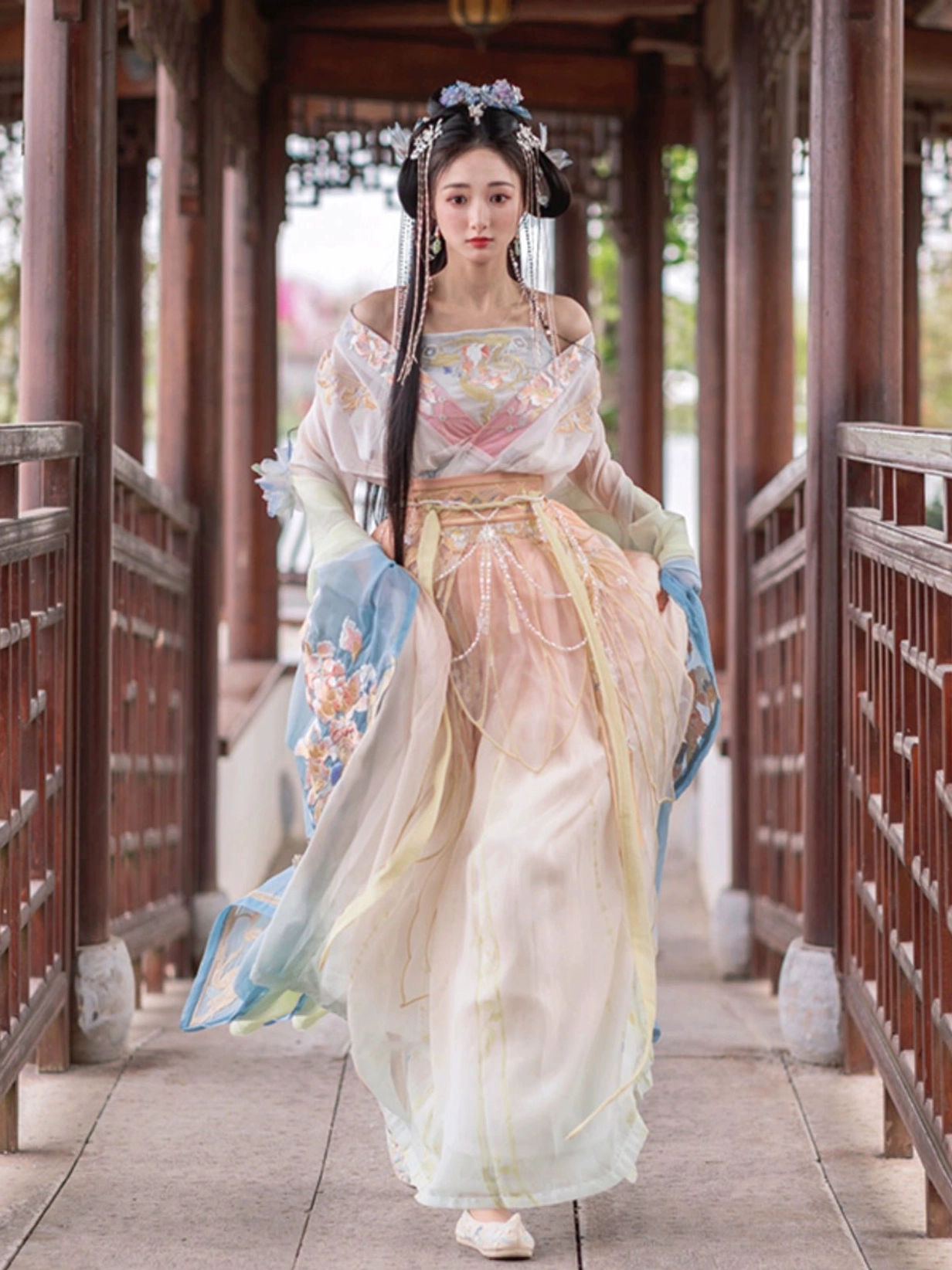 Front view of a Wei Jin Dynasty Qiyao Ruqun Hanfu in a dreamy apricot and light blue gradient, featuring wide sleeves, floral embroidery, and an elegant traditional Chinese silhouette
