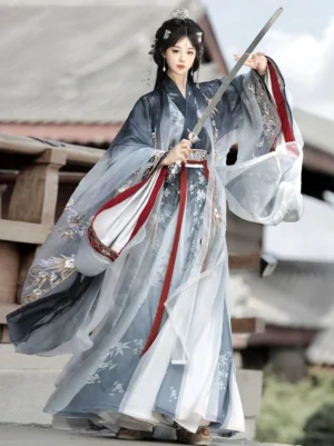 Wei Jin Dynasty Qiyao Ruqun Hanfu Dream Walking full set with indigo to ivory ombre fabric, red sleeve trim, floral and bamboo embroidery, wide flowing sleeves, and a female model holding a long sword in an ancient Chinese courtyard