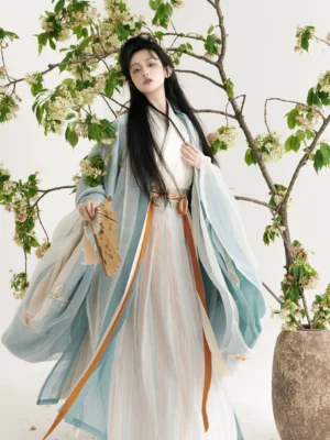 Wei Jin Dynasty Qiyao Ruqun Hanfu three quarter front view with dusty blue wide sleeves butterfly embroidery ivory inner dress and dual tone waist ribbons