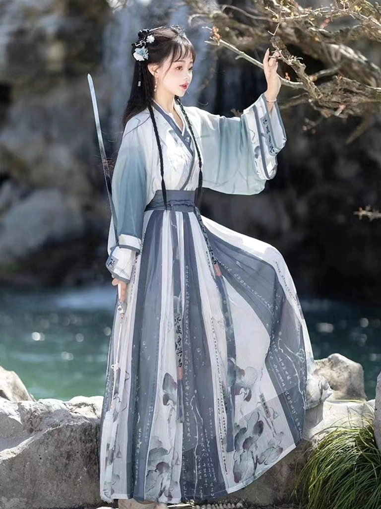 Dusty blue Wei Jin Dynasty Qiyao Ruqun Hanfu set with wide sleeves and lotus printed skirt styled with a traditional sword prop