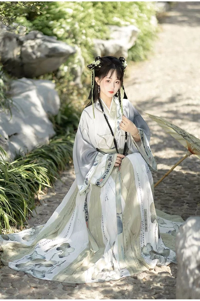 Ethereal Wei Jin Dynasty Qiyao Ruqun Hanfu with flowing printed pleated skirt and oil-paper umbrella in a traditional garden