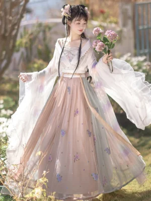 Front view of Wei Jin Dynasty Qiyao Ruqun Hanfu with wide translucent sleeves, pastel pink and blue gradient skirt, floral embroidery, waist sash, and traditional hair accessories