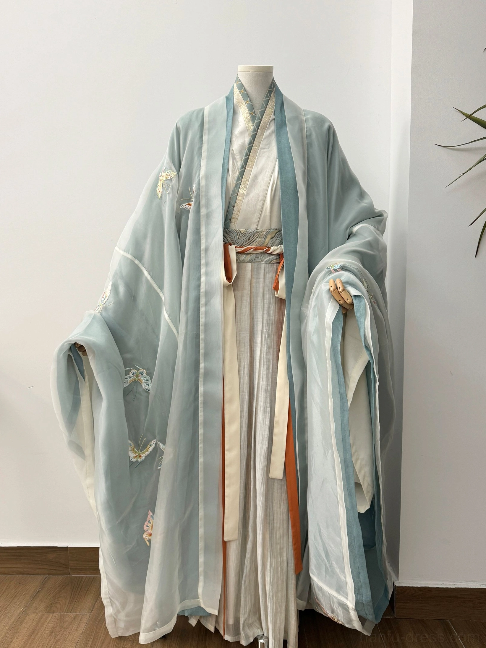 Complete Wei Jin Dynasty Qiyao Ruqun Hanfu full set displayed on dress form with layered flowing fabric contrast trims and subtle embroidery
