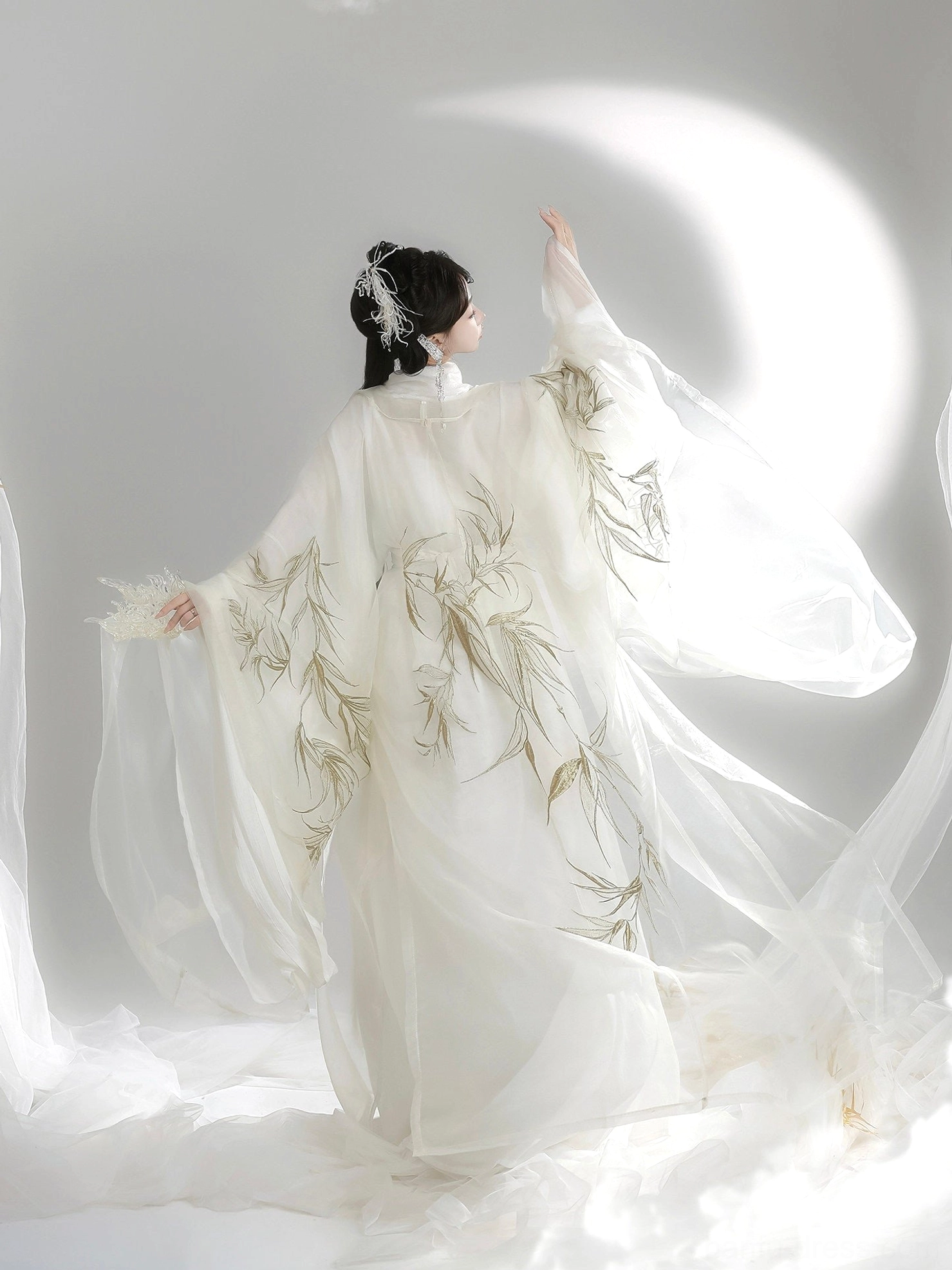 Back view of Wei Jin Dynasty inspired Qiyao Ruqun Hanfu showing golden bamboo embroidery, extra wide flowing sleeves, and long cream skirt