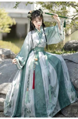 Wei Jin Dynasty Qiyao Ruqun Hanfu set in mint green and ivory with lotus calligraphy print skirt in a classical Chinese garden