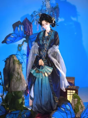 Wei Jin Dynasty Qiyao Ruqun Hanfu full-body view showing peacock-inspired indigo outer coat flowing blue skirt wide sleeves and folding fan