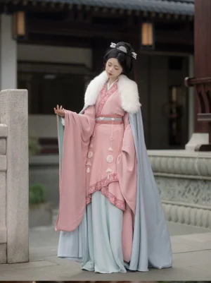 Wei Jin Dynasty Qiyao Ruqun Hanfu full set with pink cross-collar top light blue flowing skirt white fur-trimmed cloak and jade waist pendants in an ancient Chinese courtyard