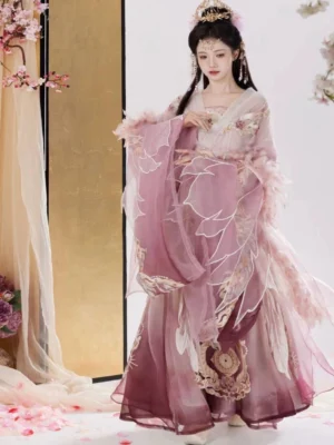 Front three-quarter view of a Wei Jin Dynasty Qiyao Ruqun Hanfu in a pink and purple gradient with feather-trimmed wide sleeves, floral embroidery, golden skirt details, and traditional Chinese styling