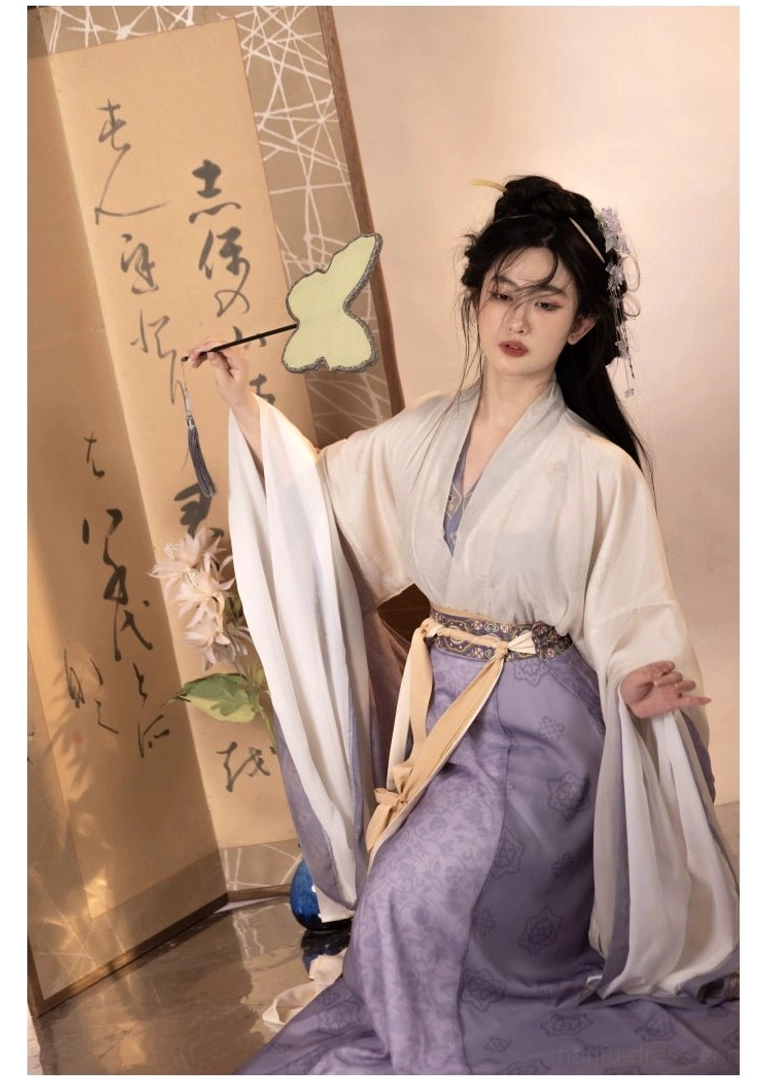 Wei Jin Dynasty-inspired purple Qiyao Ruqun Hanfu in a kneeling pose with layered sleeves, green leaf fan, and delicate hair accessories