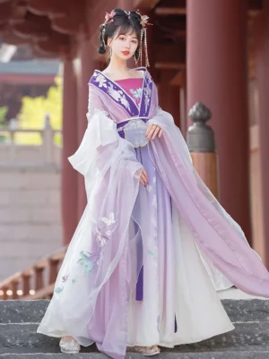 Purple and white Wei Jin Dynasty Qiyao Ruqun Hanfu full set with embroidered floral details, wide cross-collar sleeves, and flowing wrap skirt modeled in a traditional Chinese courtyard