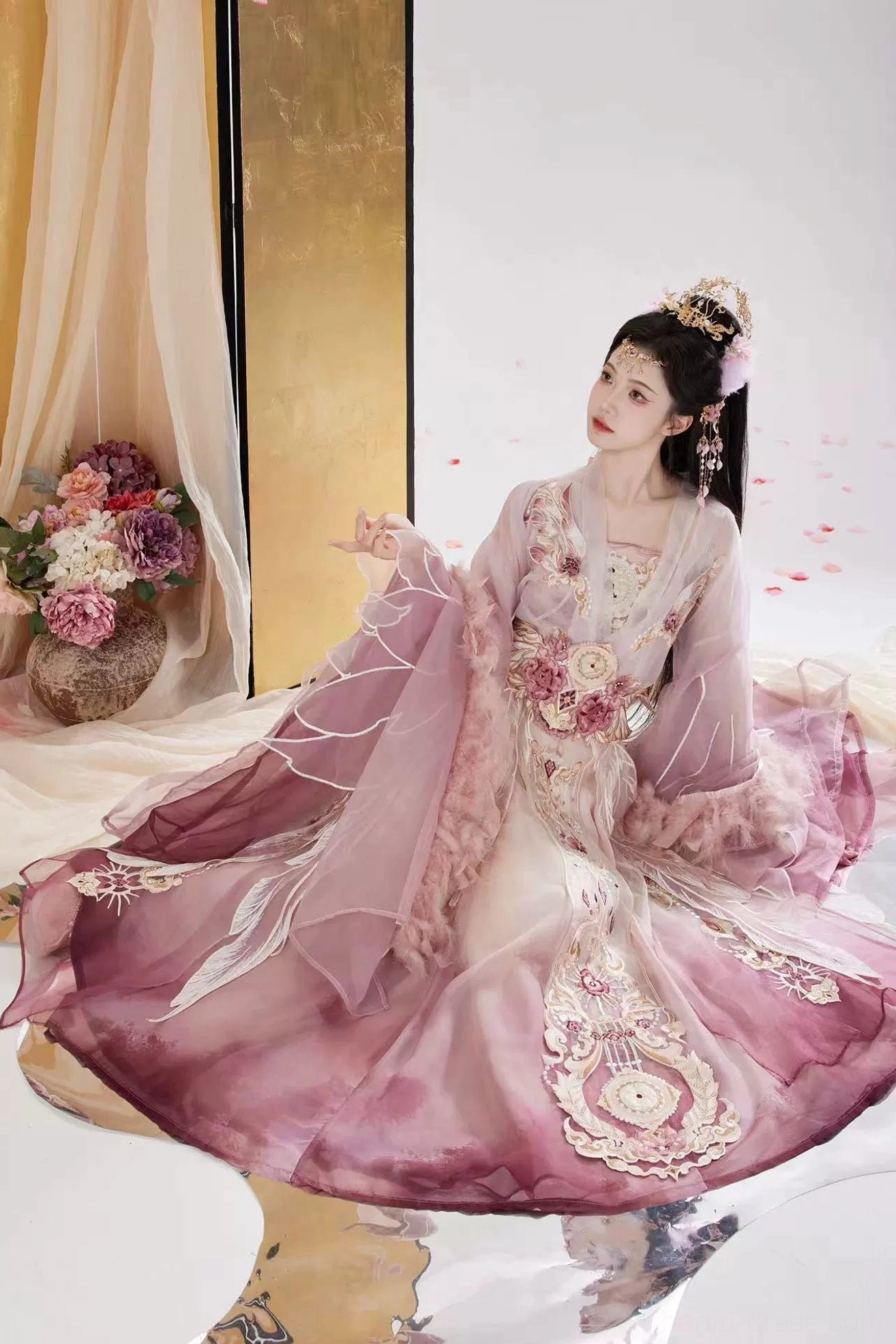 Romantic seated view of a Wei Jin Dynasty Qiyao Ruqun Hanfu with spread gradient skirt, large floral embroidery, feather-trimmed sleeves, and dreamy traditional Chinese styling