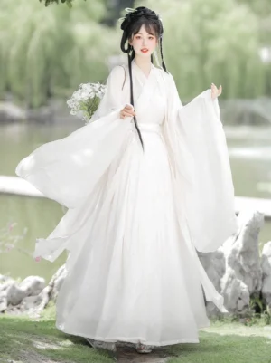 Wei Jin Dynasty qiyao ruqun Hanfu set in ivory white, shown in a three-quarter full-body view with flowing wide sleeves and a long skirt in a classical Chinese garden