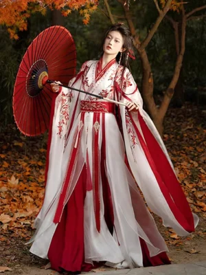 Red and white Wei Jin Dynasty Qiyao Ruqun Hanfu set with floral embroidery, wide flowing sleeves, layered skirt, and red oil paper umbrella in an autumn garden
