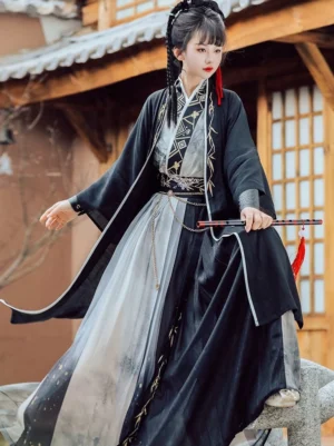 Wei Jin Dynasty warrior Qiyao Ruqun Hanfu full body view with black outer robe, white trim, ink wash gradient pleated skirt, golden bamboo embroidery, waist chain, and red tassel accessory
