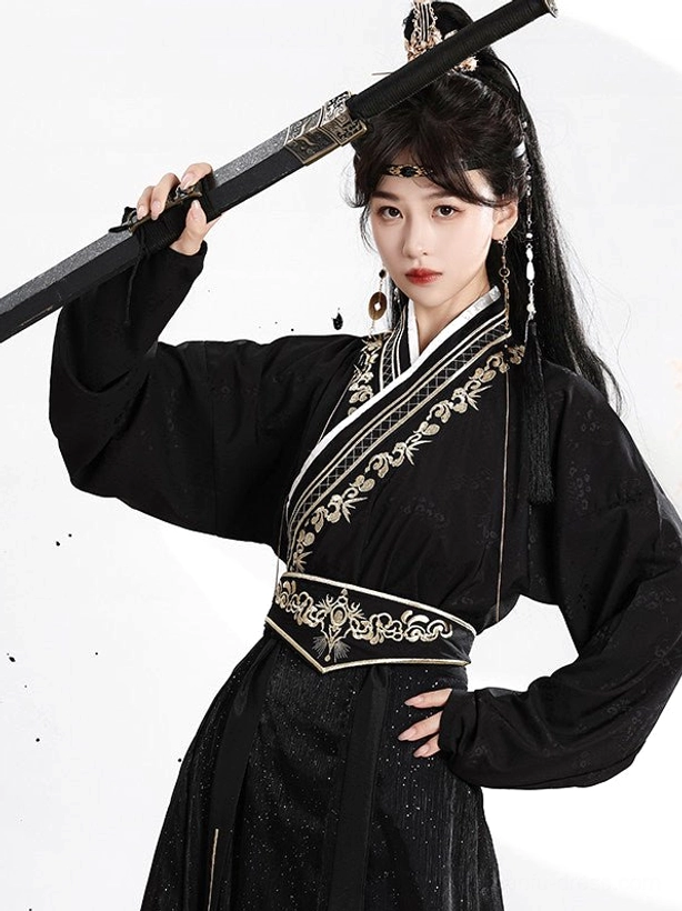 Close-up detail of black Wei Jin Hanfu cross collar with gold floral and bamboo embroidery, waist sash, and traditional Chinese hair tassel accessories