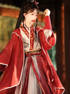 Close three-quarter view of red Wei Jin style Hanfu warrior outfit with embroidered cross collar, finger cuffs, golden waist trim, and flowing outer coat