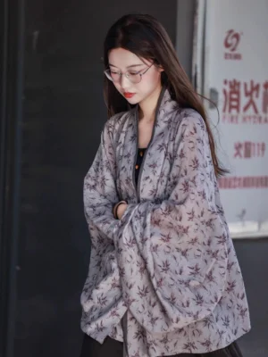 Three-quarter front view of a loose Wei-Jin inspired bamboo print Hanfu cardigan with oversized sleeves, textured fabric, and relaxed everyday fit
