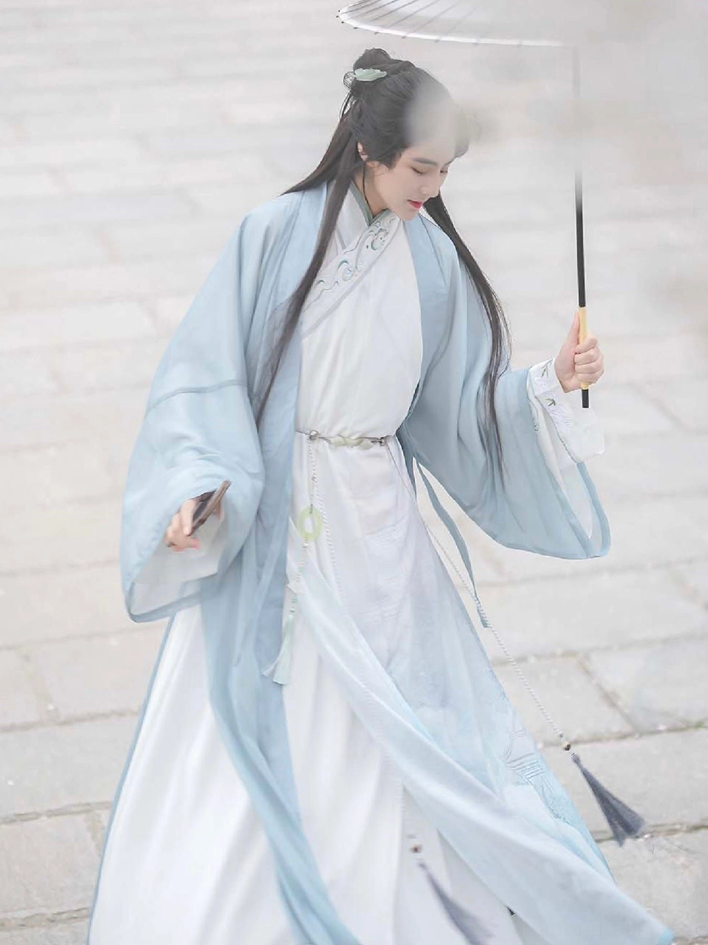 Wei Jin style male hanfu with tied waist sash, floor length flowing skirt, embroidered cuffs, and oil paper umbrella