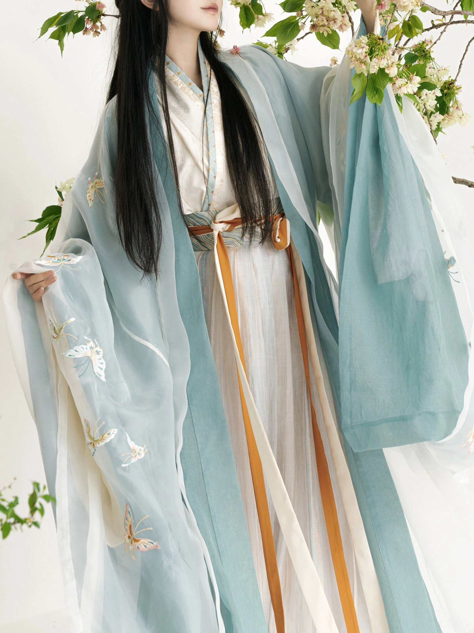 Close up Wei Jin Qiyao Ruqun Hanfu sleeve detail with delicate butterfly embroidery contrasting collar trim and dual color waist sashes