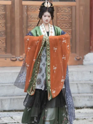 Wei Jin style Qiyao Ruqun Hanfu full outfit shown at a traditional wooden palace doorway, featuring orange floral sleeves, dark blue side panels and geometric hexagon sleeve trim