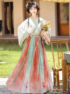 Front three-quarter view of a Wei Jin Dynasty Qiyao Ruqun Hanfu with white cross-collar top, red green and ivory gradient skirt, floral embroidery and traditional Chinese courtyard styling