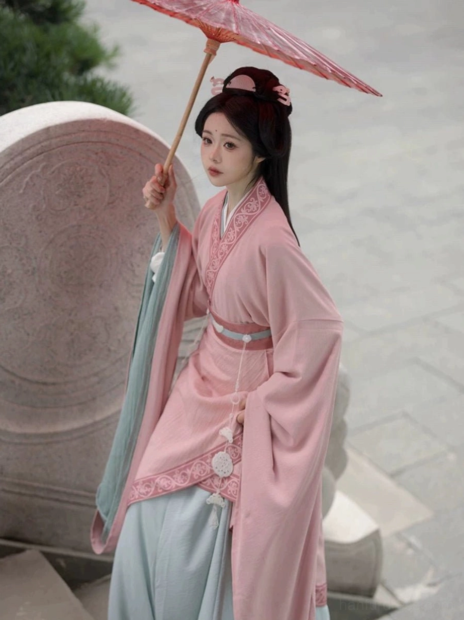 Wei Jin Dynasty Qiyao Ruqun Hanfu without cloak featuring pink cross-collar top light blue skirt jade waist decoration and red traditional Chinese paper umbrella