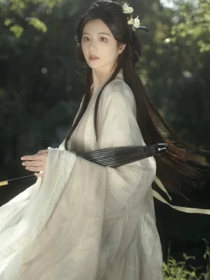 Ethereal Wei Jin style Chinese Hanfu costume with sheer off-white layers, cross-collar robe, long flowing sleeves, white flower hairpins, and black paper umbrella