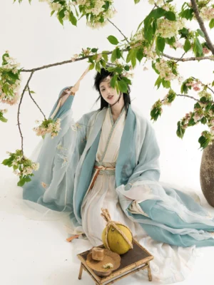 Wei Jin style layered Qiyao Ruqun Hanfu seated model view showing flowing sheer sleeves classic cross collar structure and butterfly embroidery