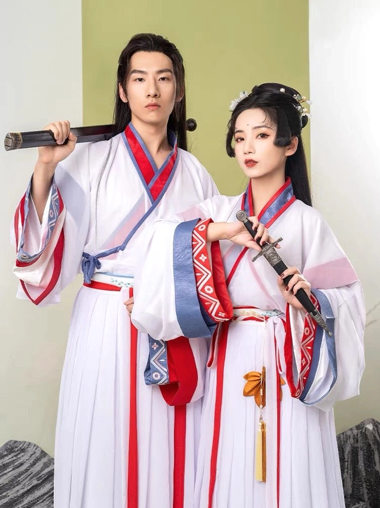 Wei Jin xianxia hanfu couple posing with traditional sword and sword sheath, wearing matching white outfits with red and blue geometric trim and decorative waist sashes