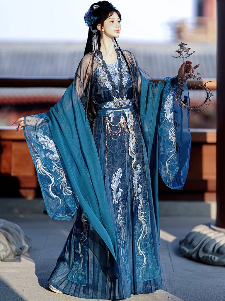 West Sea Dragon Queen Hanfu in deep teal blue with wide chiffon sleeves, silver and gold dragon embroidery, flowing water motifs, and sheer neckline