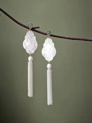 White carved shell Hanfu tassel Chinese earrings hanging from a dark red branch with pearl and green jade accents