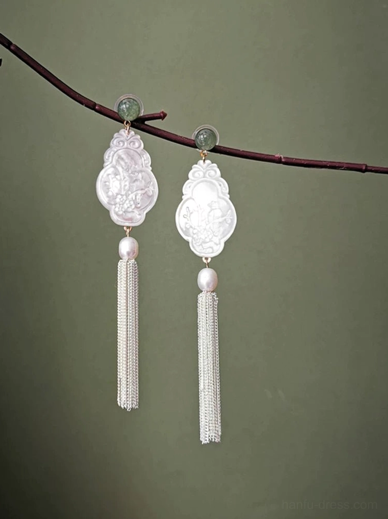 White carved shell Hanfu tassel Chinese earrings hanging from a dark red branch with pearl and green jade accents