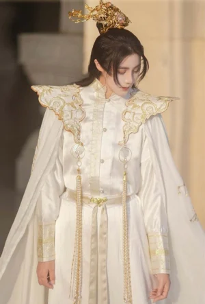 Close-up of white and gold fantasy imperial Hanfu collar top with ornate embroidered shoulder armor style details and pearl tassels