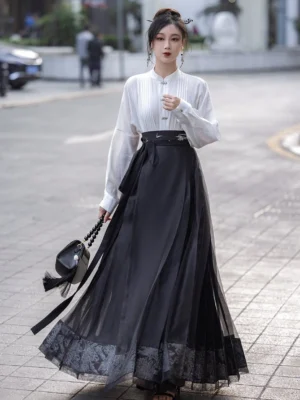 White stand collar Hanfu blouse and black sheer mamian skirt outfit shown in an urban street setting