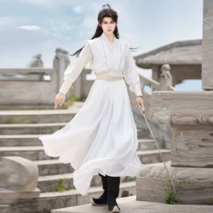 White men's Wei-Jin style Hanfu with flowing wide sleeves, beaded collar, matching waist belt, and long skirt worn by a swordsman model on ancient stone steps
