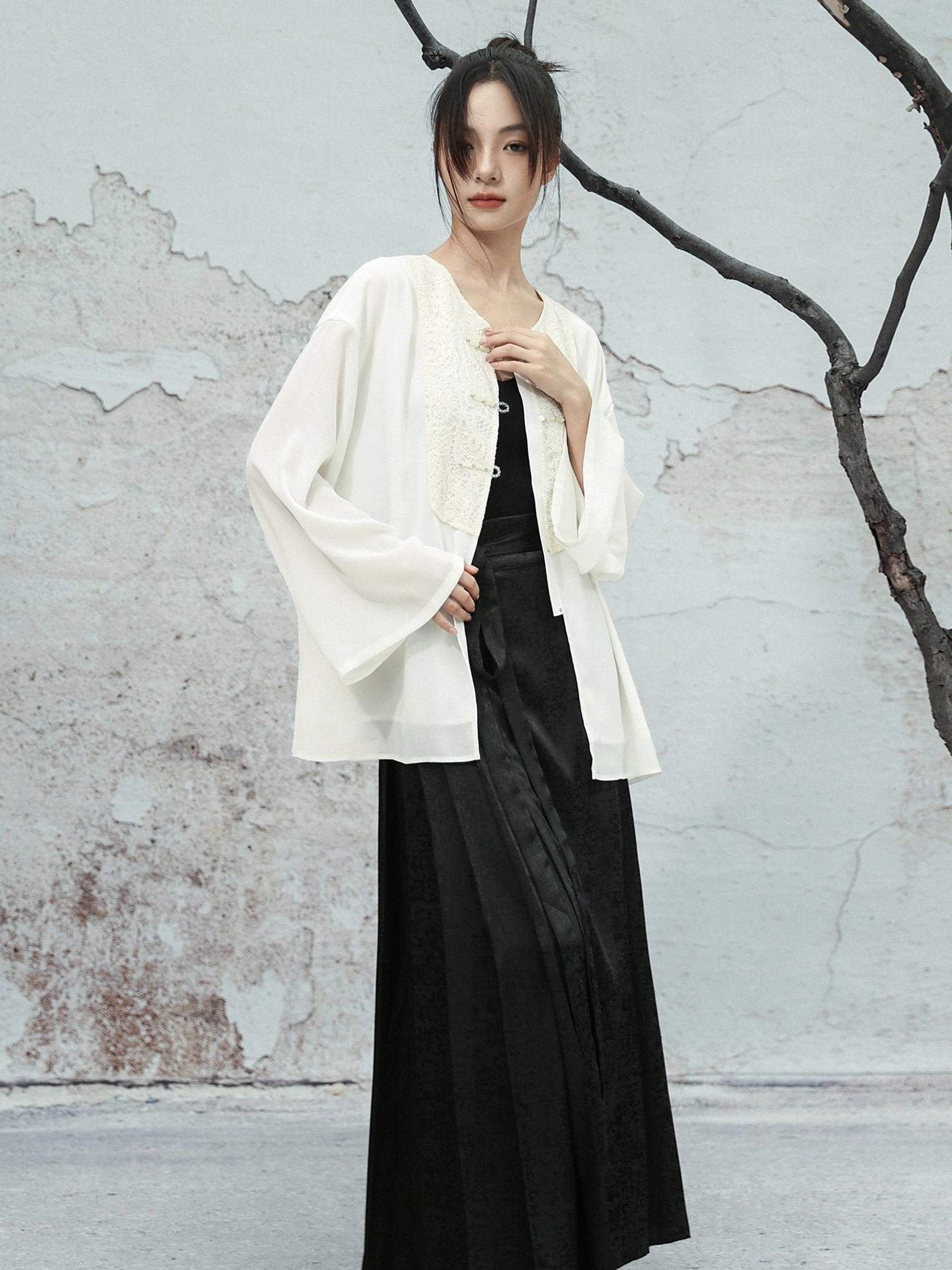 Side three-quarter view of a white Modern Hanfu chiffon blouse showing loose long sleeves, V-neckline, and detailed lace embroidery