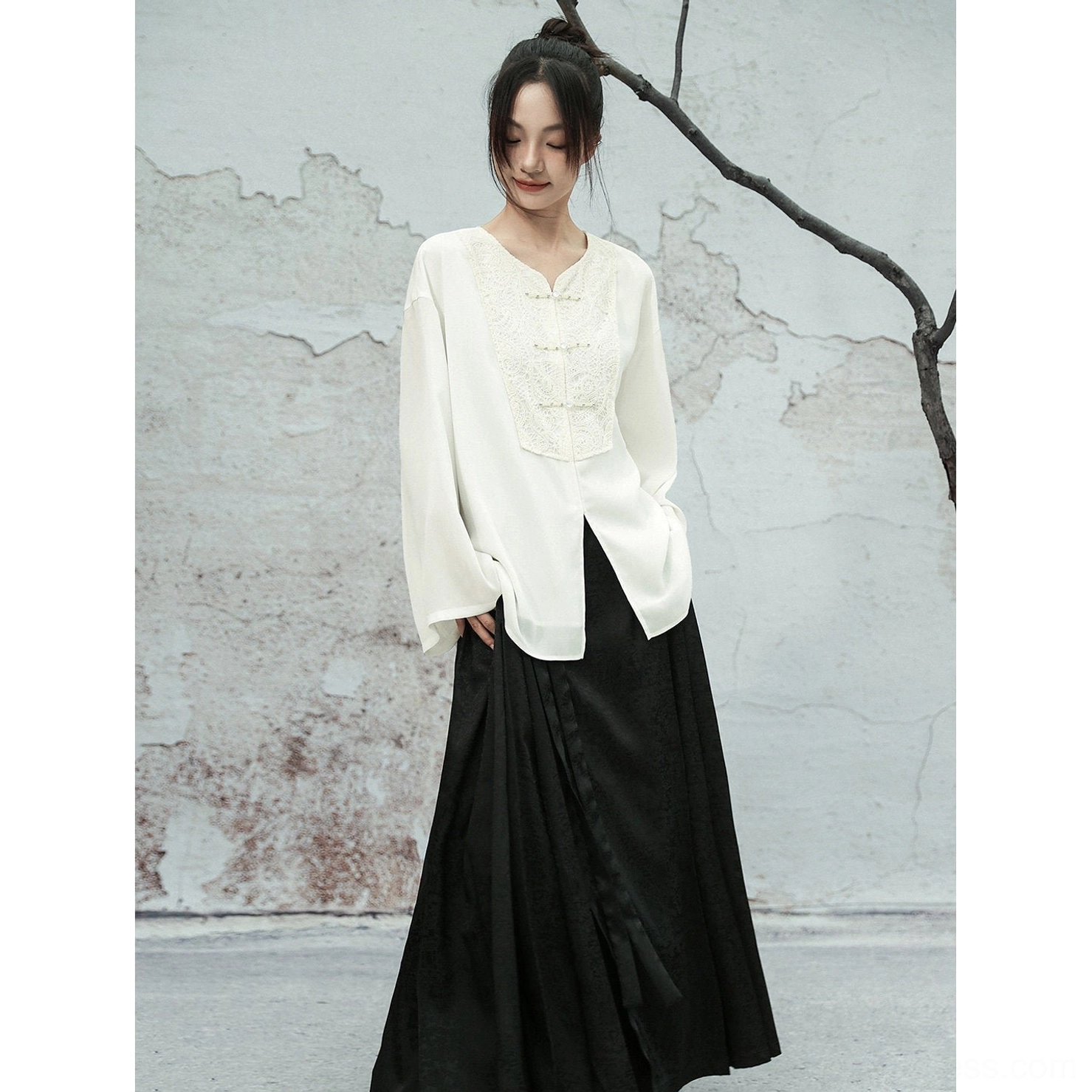Side view of a white Modern Hanfu chiffon top with lace embroidered front panel, relaxed silhouette, flowing sleeves, and split hem