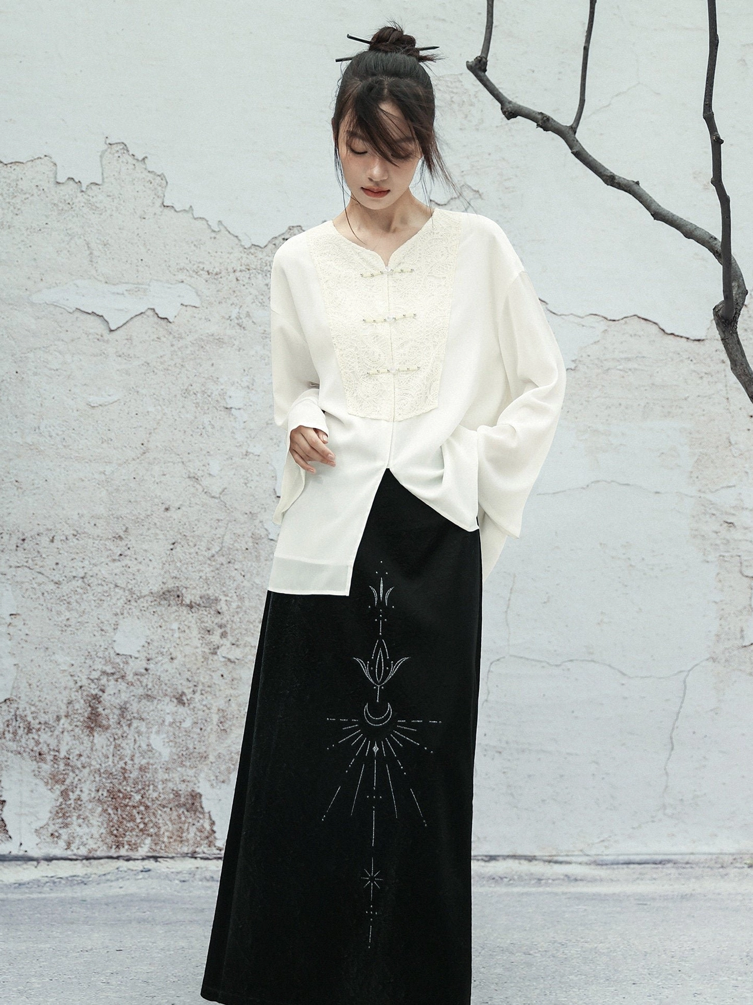 White Modern Hanfu embroidered blouse styled with a black celestial pattern maxi skirt and relaxed long sleeve silhouette