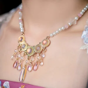 White Moon Chinese style yingluo necklace worn with Hanfu, featuring pearl beads, gold filigree centerpiece, pink accents, and cascading purple crystal tassels