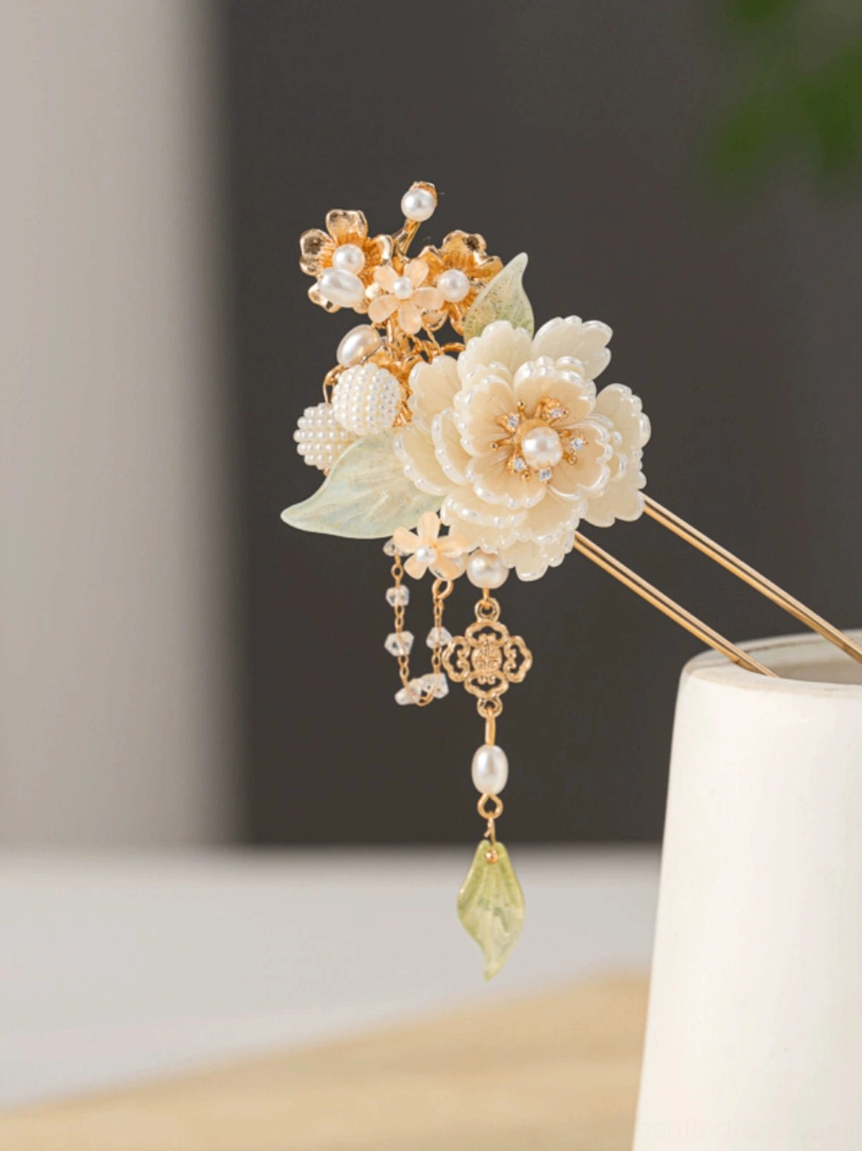 White peony Hanfu hairpin with pearl decoration, pale green leaves, gold-tone stick, and elegant Chinese-style tassel pendant