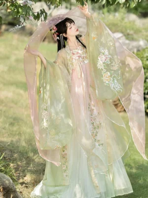 Tang Dynasty Hanfu Heziqun dress in a pink to light green gradient with floral embroidery and sheer wide-sleeve cape worn outdoors