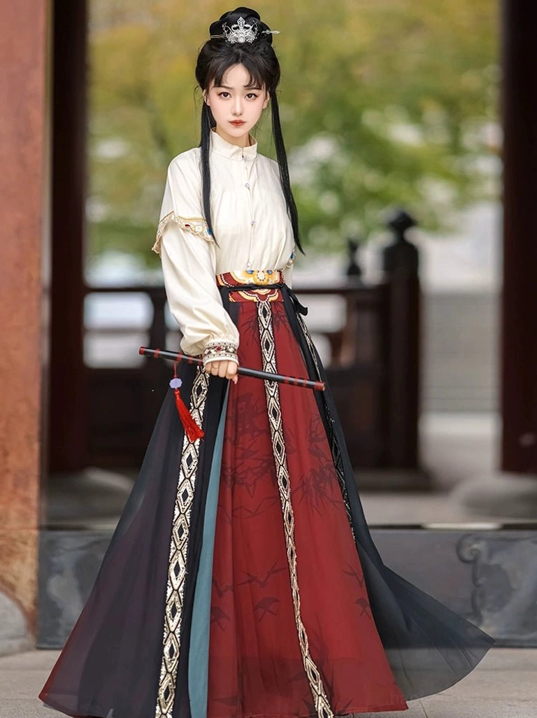 White puff sleeve Tang-style hanfu shirt with bamboo printed high-waist wrap skirt and geometric trim in an outdoor Chinese garden
