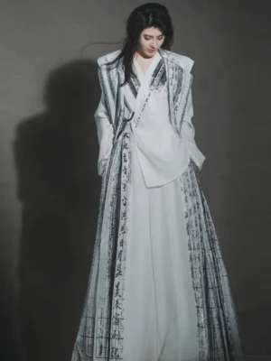 White reversible Thousand Character Classic Hanfu robe coat with vertical Chinese calligraphy print, flowing longline silhouette, wide lapel, and dramatic traditional Chinese fashion styling