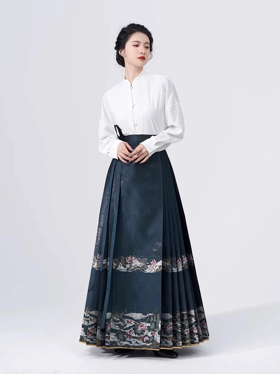 White stand-collar Chinese blouse paired with a solid dark teal pleated mamian skirt in a traditional Hanfu outfit