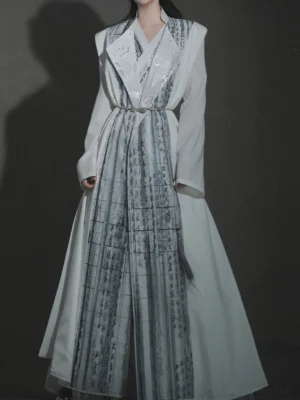 Back three-quarter view of a white Chinese-style Thousand Character Classic long coat with vertical calligraphy panels, waist belt styling, and flowing Hanfu robe design