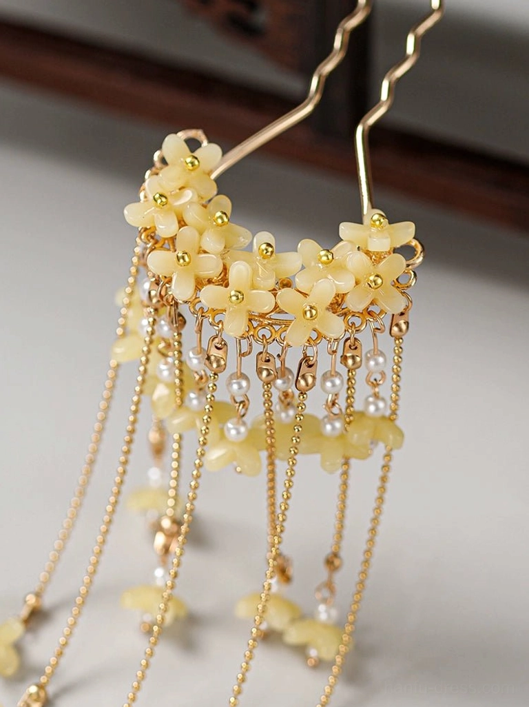 Close up of creamy yellow floral cluster on wind chimes tassel Hanfu hair fork with gold tone chains, pearl accents, and flower pendants