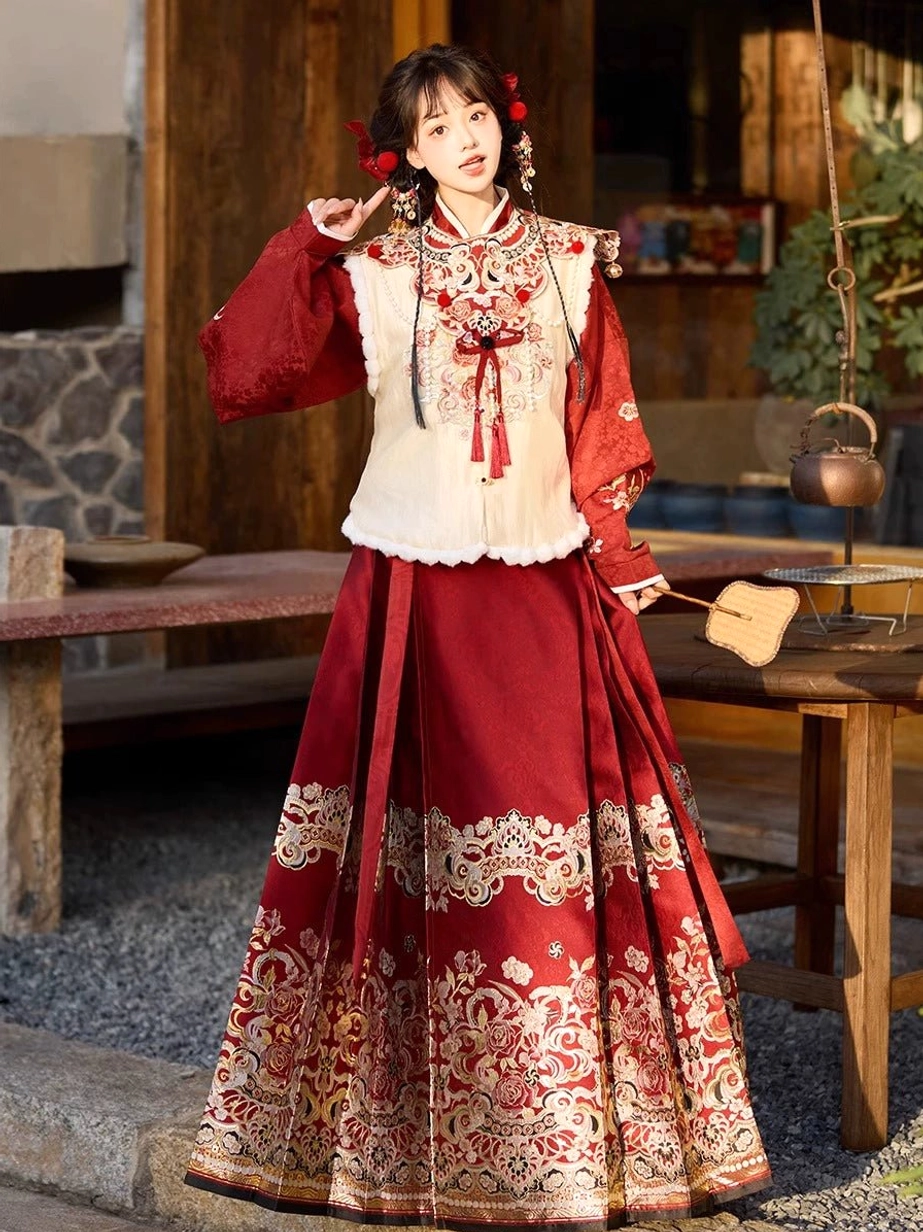 Side front view of wine red modern Hanfu outfit with textured jacquard blouse, cream vest, embroidered horse-face skirt, tassel details, and traditional Chinese styling