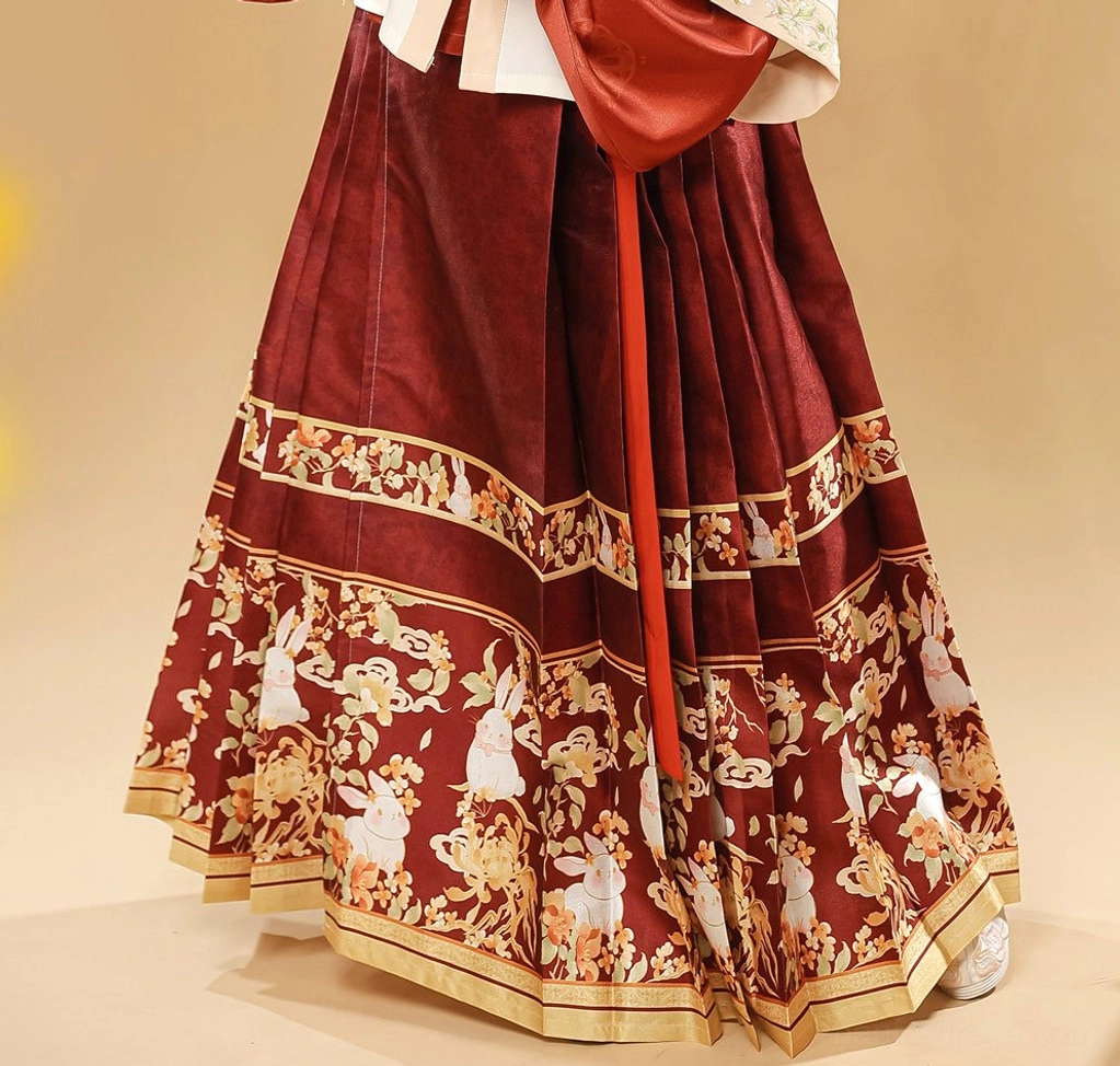 Close-up of wine red Ming Dynasty Hanfu mamian skirt with detailed rabbit and floral decorative hem print
